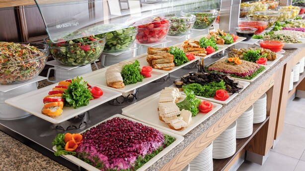 A buffet with various food options including salads, sandwiches, and a spread of fruits and vegetables. - Chinar Health Hotel Naftalan (Naftalan)