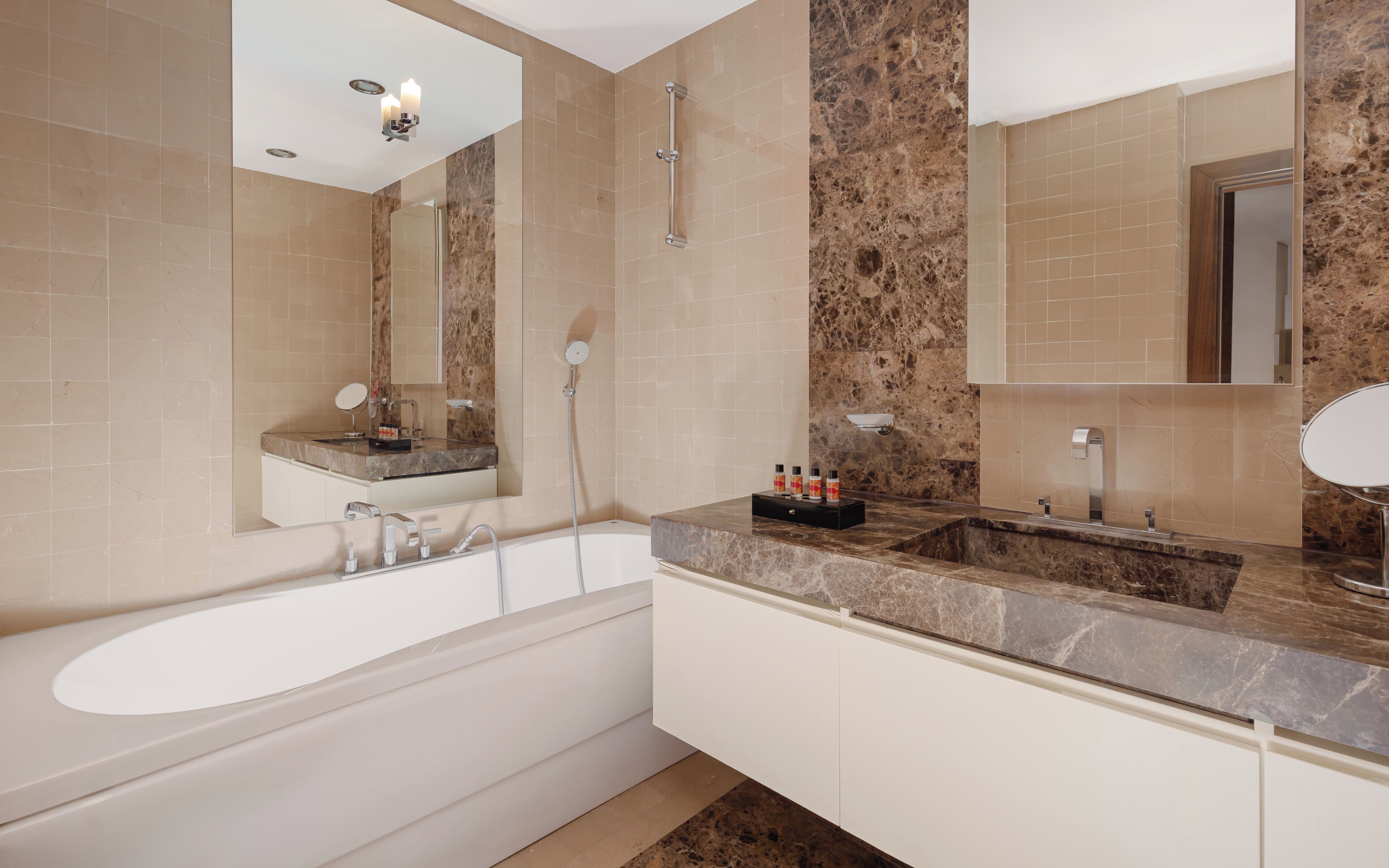 A modern bathroom with a bathtub, a sink, and a vanity.