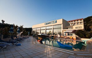 Relax by the pool at ODISSEA, where a clean deck and lounge chairs await.