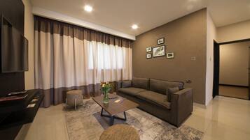 A modern living room with a sofa, coffee table, and a small rug.