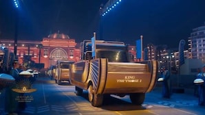 A large, ornate truck with "KING THUTMOSI" on the back, parked on a city street at night. - Downtown Inn (Cairo)