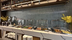 A buffet area with various food stations, including fruits, vegetables, and a selection of beverages. - Yizhi flat (Guangzhou Zhujiang New Town Huashi Subway Station Branch) (Guangzhou)