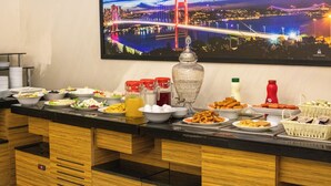 A buffet setup with various food items and condiments. - Deluxe Newport Hotel - Old City (Istanbul)