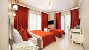 A hotel room with two beds, a desk, a chair, a TV, and a telephone. - Deluxe Newport Hotel - Old City (Istanbul)
