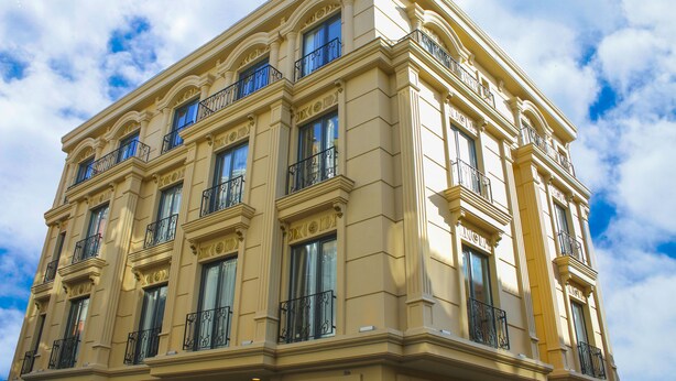 A multi-story building with classical architecture, featuring ornate balconies and large windows. - Deluxe Newport Hotel - Old City (Istanbul)