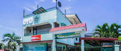A building with a sign for 'Maanyag Pension' and a 'Daily Monthly Rates' sign.