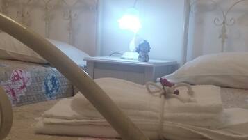 A bed with a decorative headboard, a bedside lamp, and a starfish decoration on the wall.