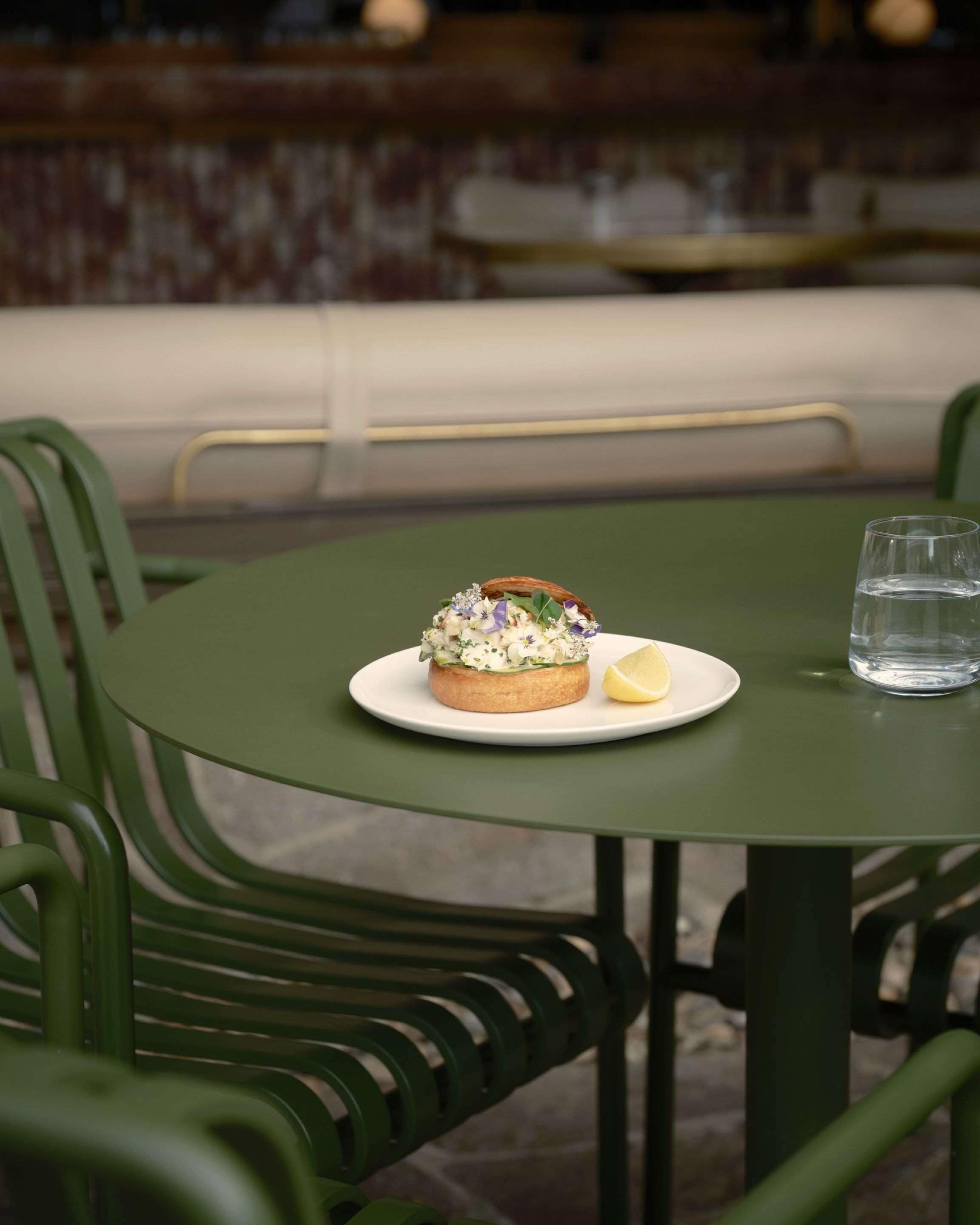 A table with a plate of food and a glass of water.