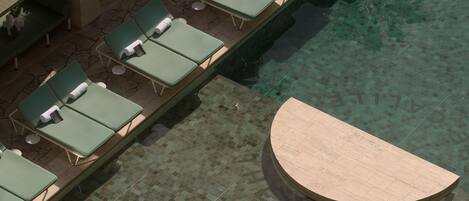 An outdoor pool area with lounge chairs and a circular seating area.