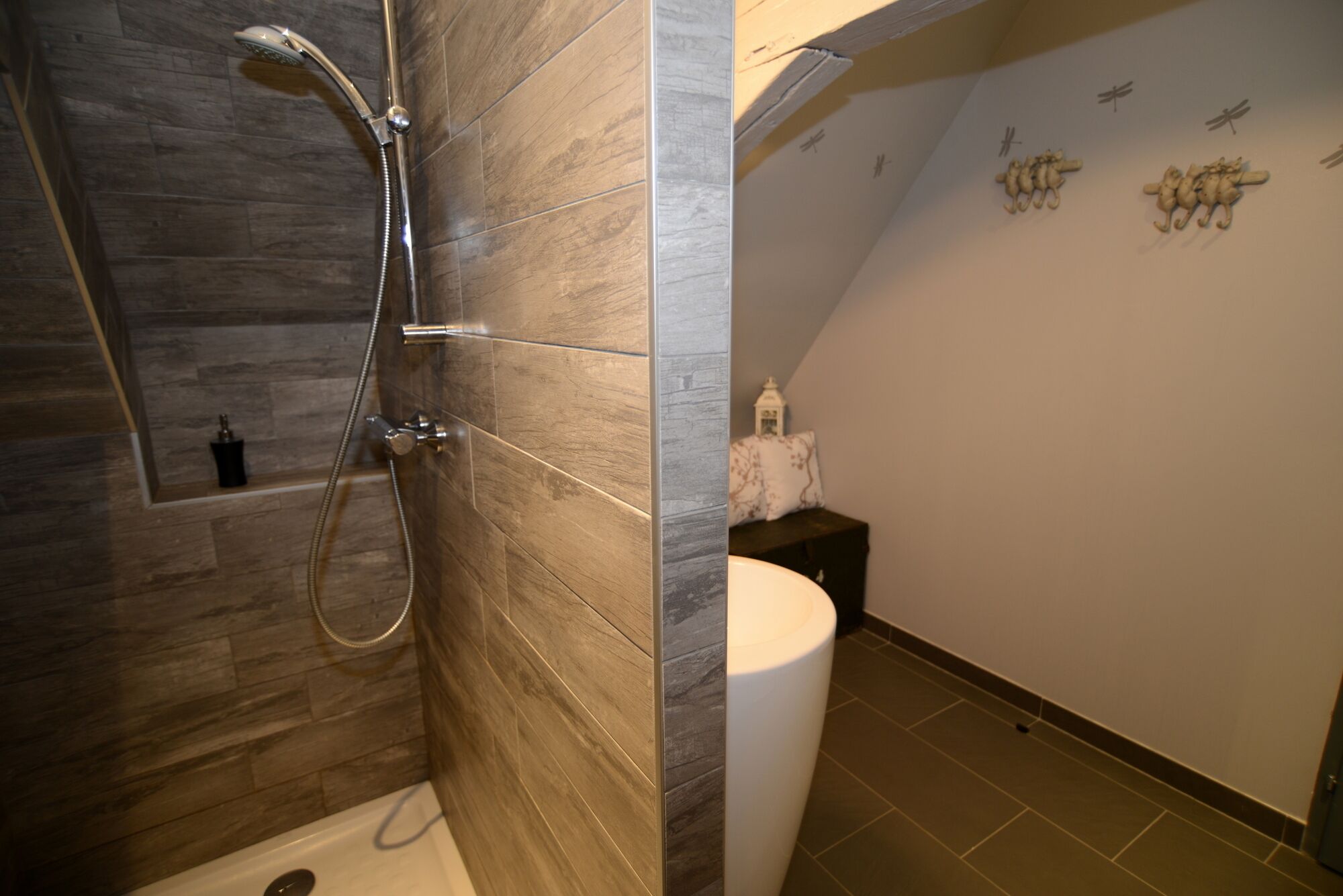 A modern bathroom with a shower, a toilet, and a sink.
