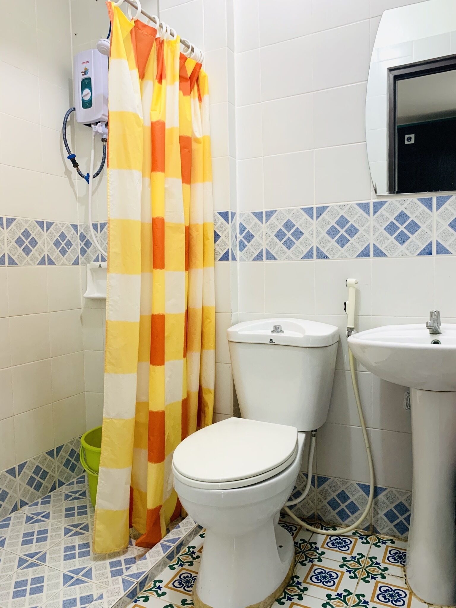 A bathroom with a toilet, a sink, and a shower curtain.