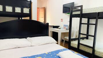 A bunk bed room with a desk, a television, and a "No Smoking" sign.