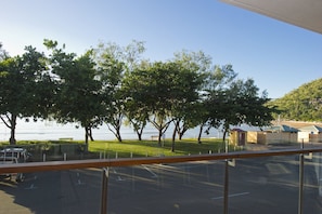A parking lot with a view of a lake and trees.