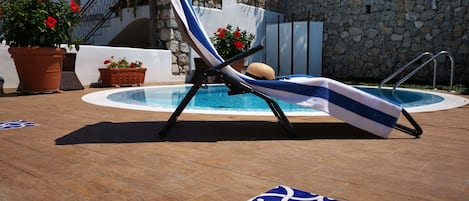 Seasonal outdoor pool, open 11:00 AM to 6:00 PM, sun loungers