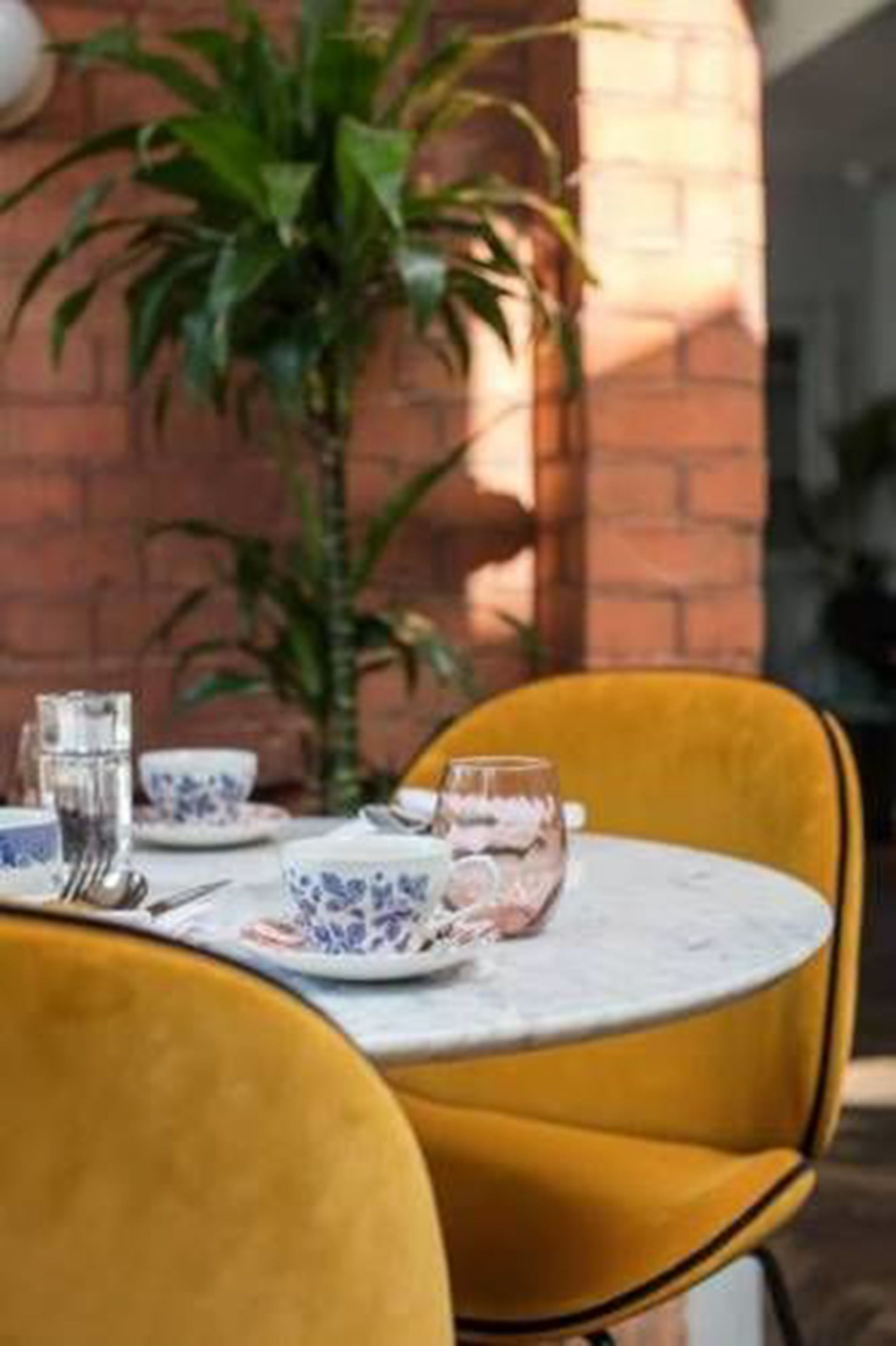 A table set with blue and white patterned plates, a glass, and a fork.