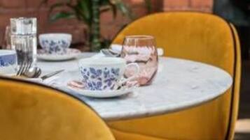 A table set with blue and white patterned plates, a glass, and a fork.