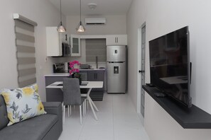 Suite estudio ejecutiva, 1 cama King size, cocina | Área de sala de estar | Televisión LED