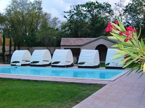 Seasonal outdoor pool, open 9:00 AM to 10:00 PM, pool umbrellas