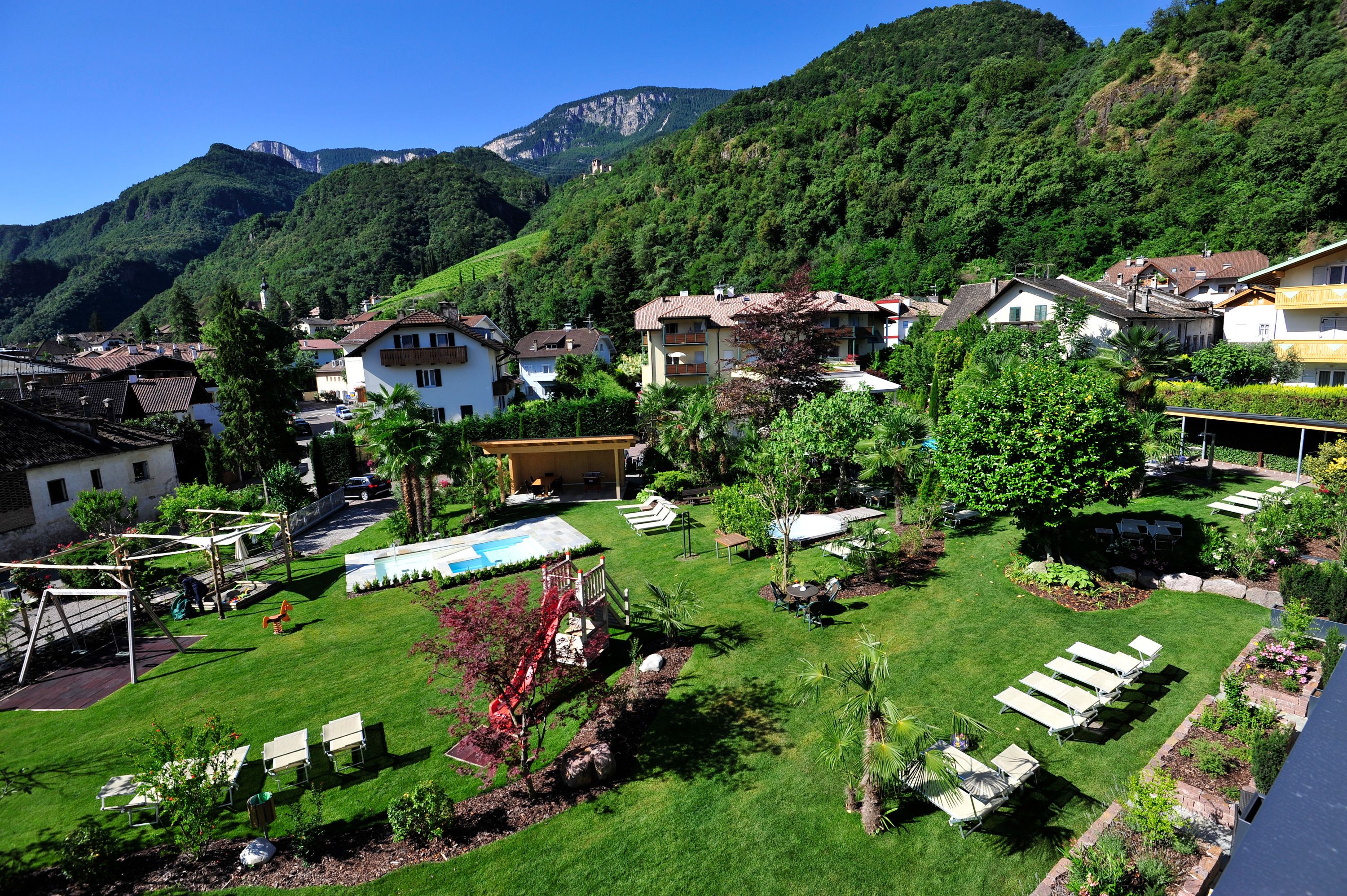 A residential area with houses, a swimming pool, and a playground.