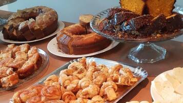 A variety of baked goods including cakes, muffins, and pastries on display.