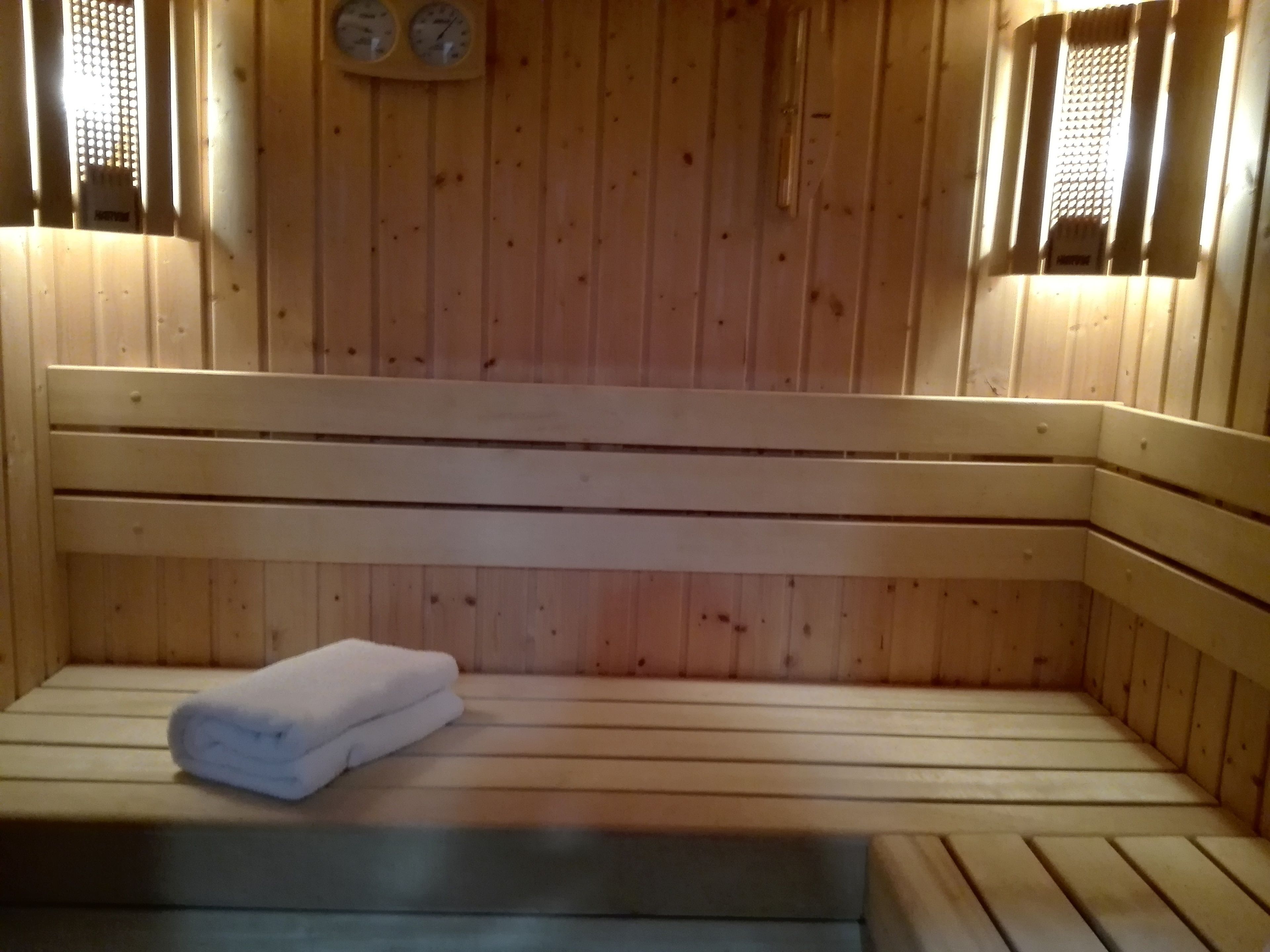 Una sauna de madera con bancos y una toalla.