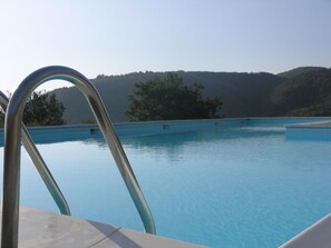 Outdoor pool, a rooftop pool, pool loungers
