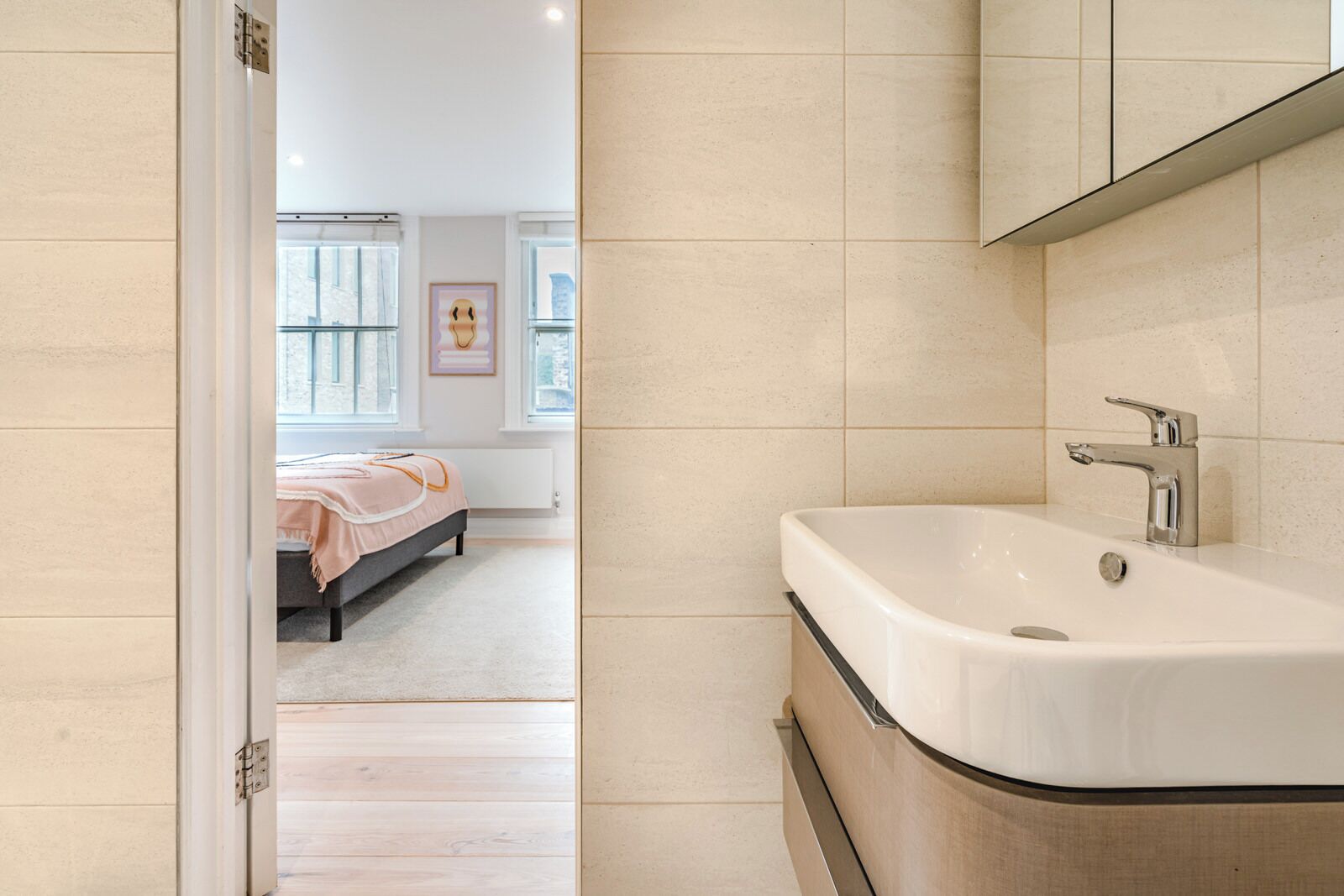 A modern bathroom with a large sink and a mirror above it.