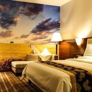 A hotel room with a large bed, a nightstand, a lamp, and a view of a field through the window. - Delin Hotel (Shenzhen)