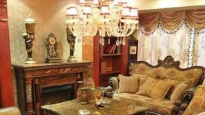 A traditional room with a fireplace, ornate furniture, and a chandelier. - Junlin Dongfang Hotel (Zhenjiang)