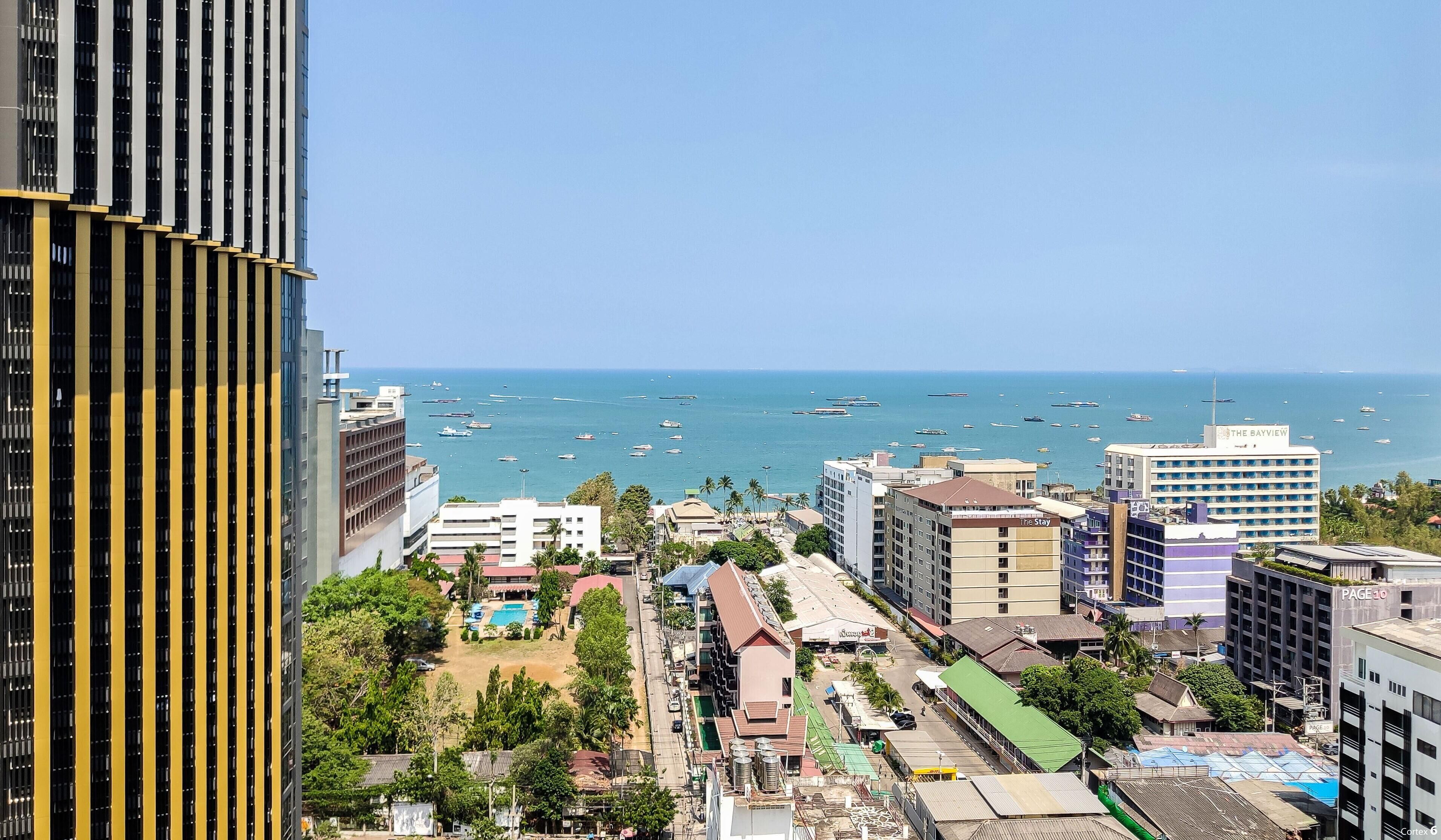 A coastal cityscape with a view of the sea, featuring buildings like 'The Bayview' and 'The Stay'.