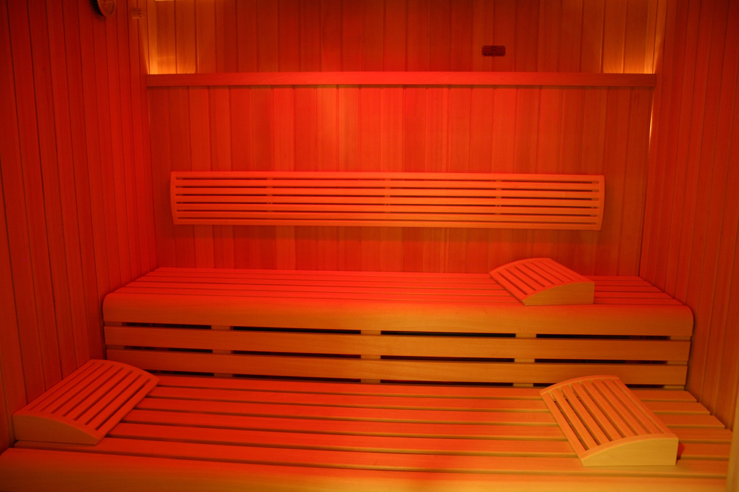 A sauna with wooden benches and benches with backrests.