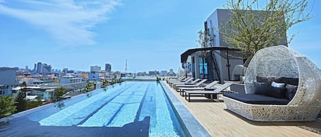 Outdoor pool, a rooftop pool, open 7:30 AM to 9:00 PM, pool loungers