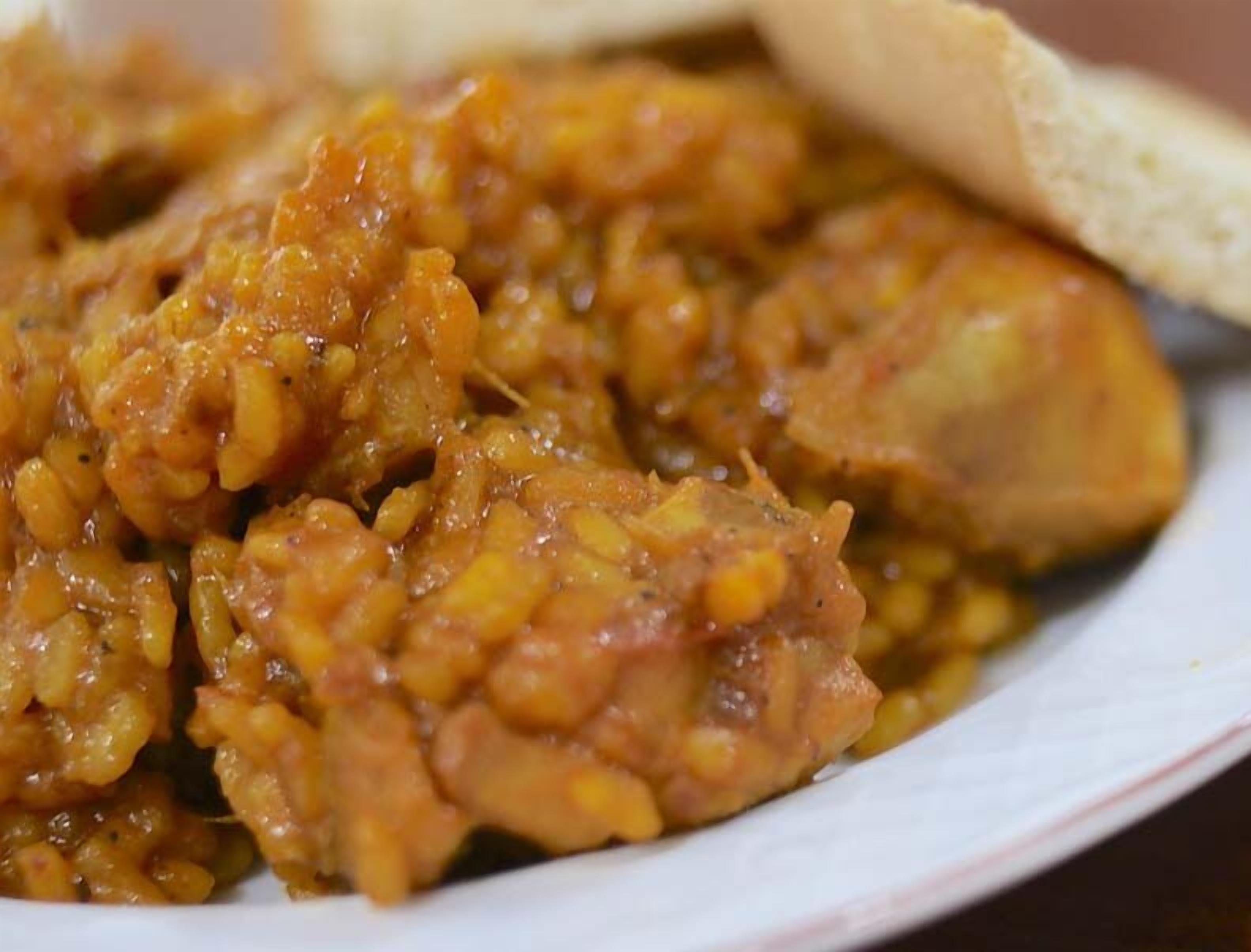 A plate of food with a piece of bread.