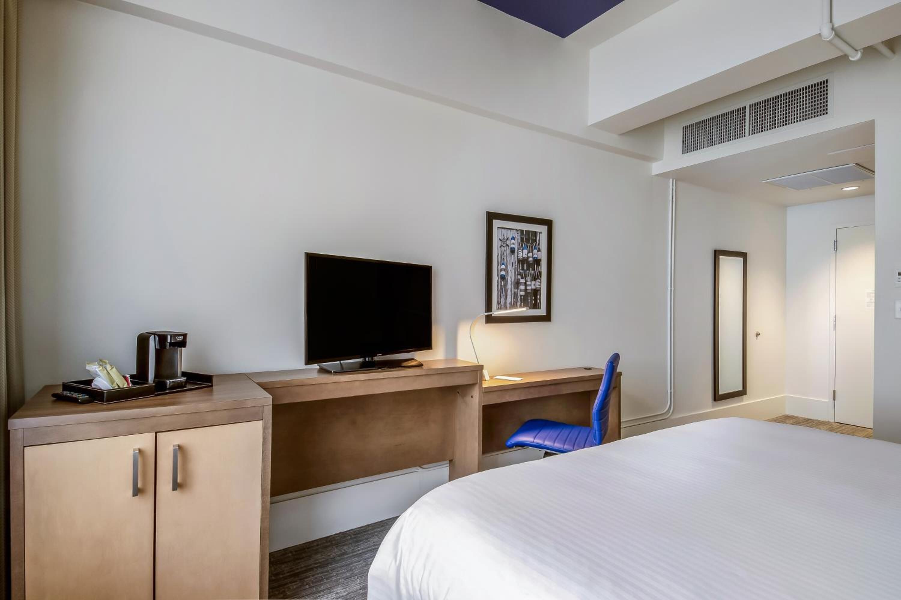 Premium bedding, desk, laptop workspace, blackout drapes