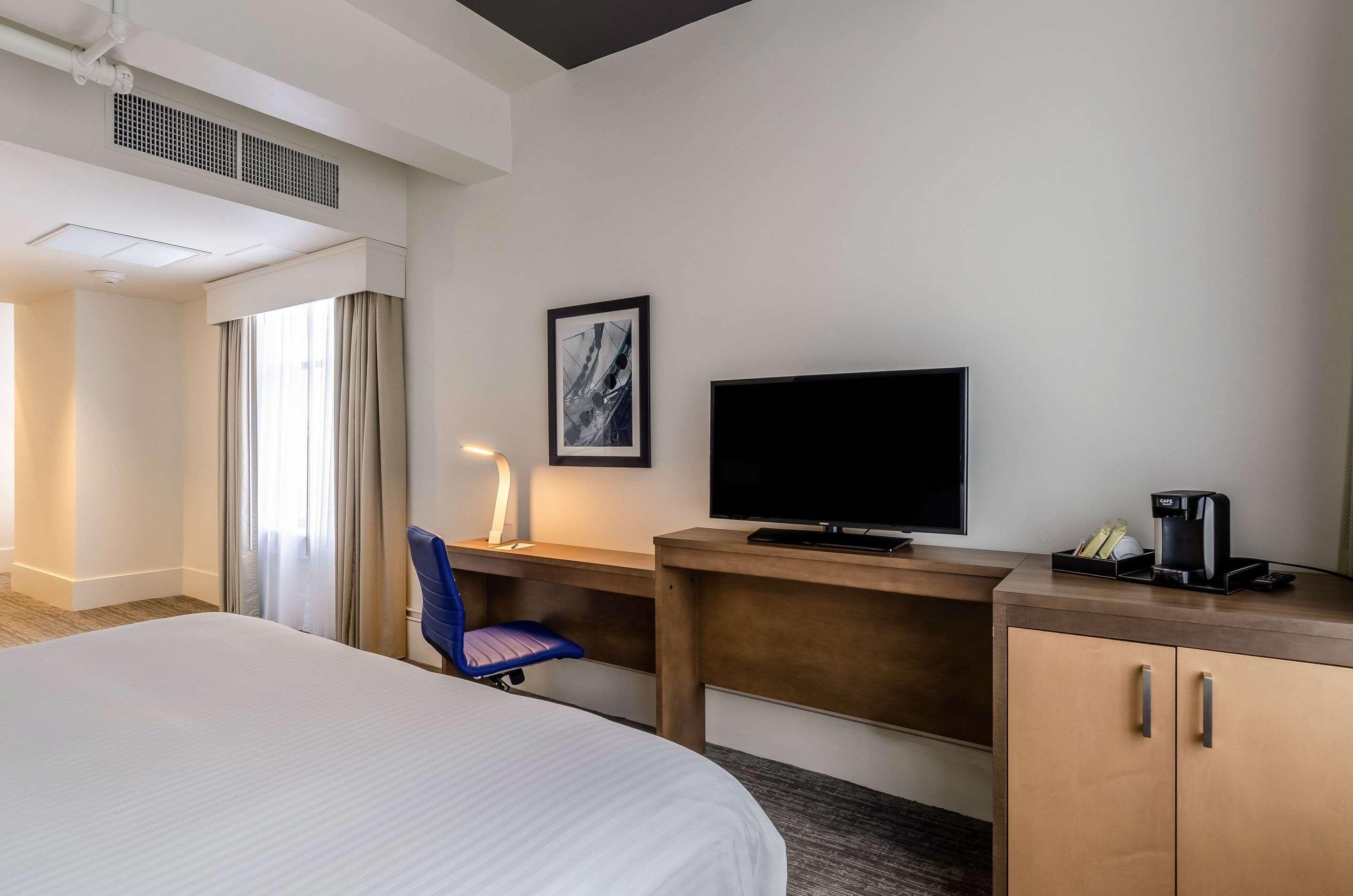 Premium bedding, desk, laptop workspace, blackout drapes