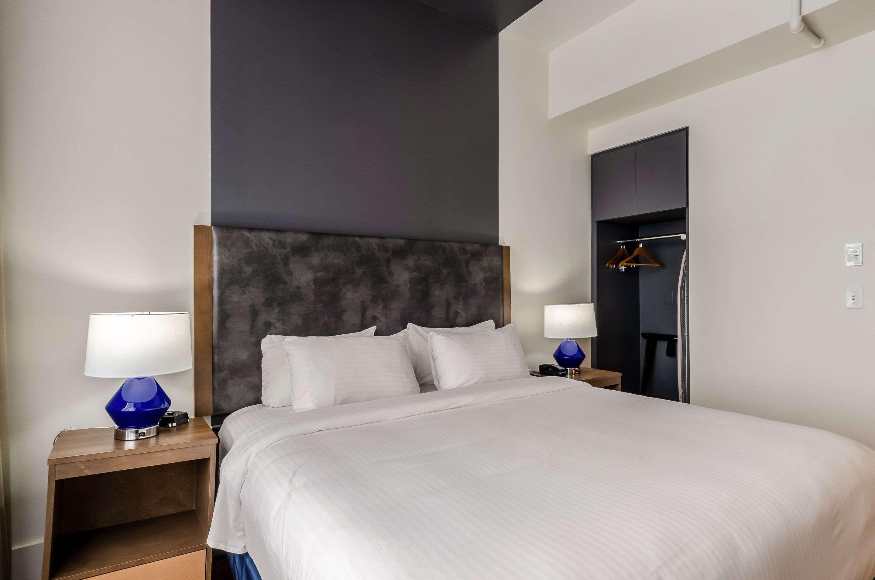 Premium bedding, desk, laptop workspace, blackout drapes