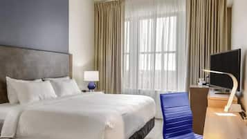 Premium bedding, desk, laptop workspace, blackout drapes