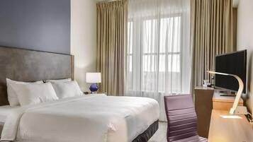 Premium bedding, desk, laptop workspace, blackout curtains
