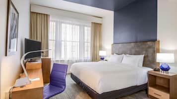 Premium bedding, desk, laptop workspace, blackout curtains