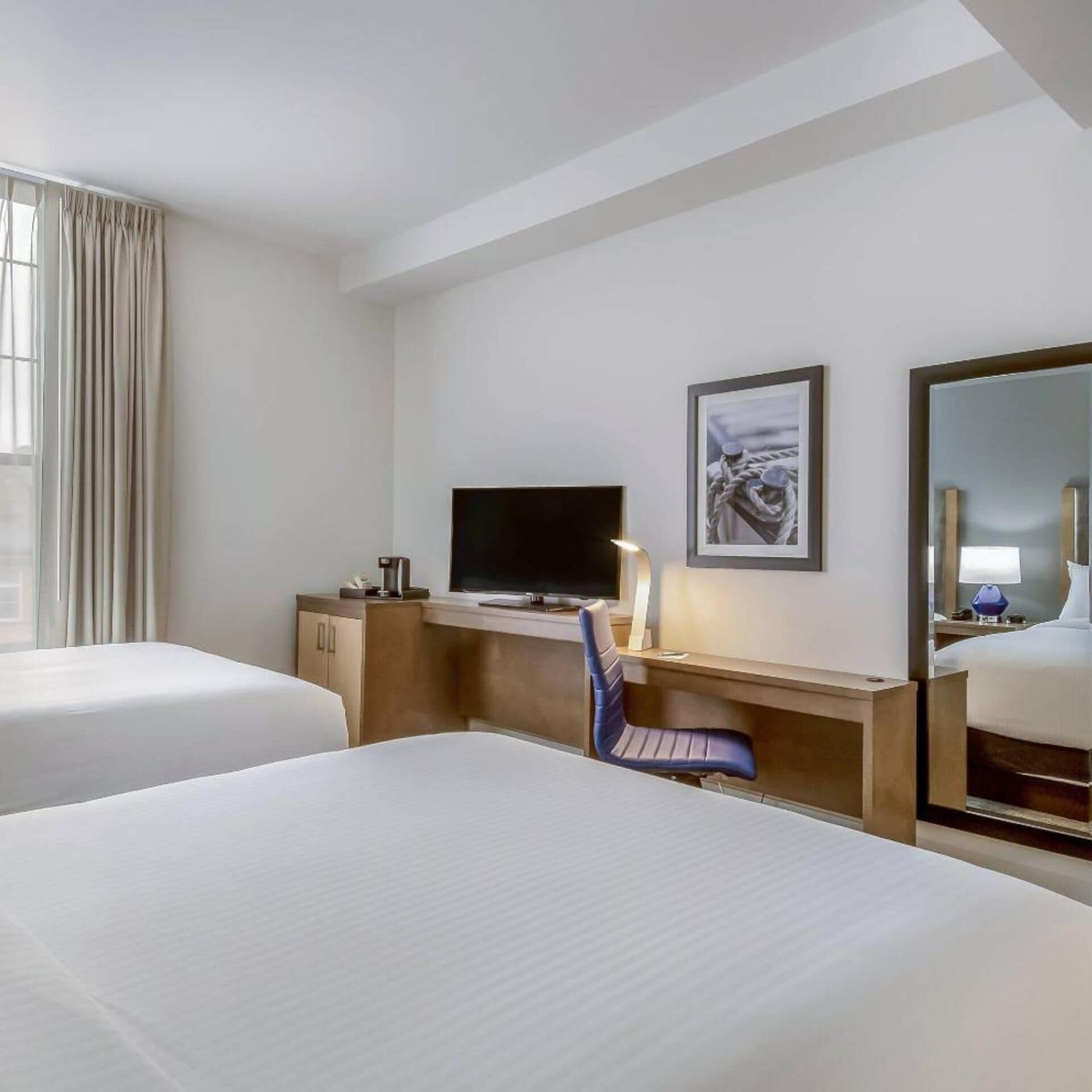 Premium bedding, desk, laptop workspace, blackout drapes