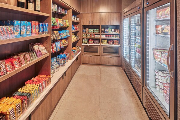 A grocery store aisle with shelves stocked with various snacks and packaged goods. - Hotel Trio Healdsburg (Healdsburg)