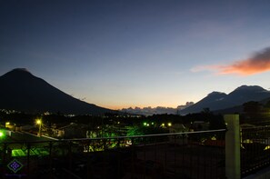 A nighttime view of a mountainous landscape with a sunset.