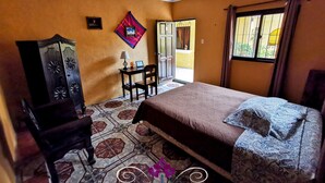 A bedroom with a bed, a chair, a desk, and a wardrobe. - Maison Bougainvillea (Antigua Guatemala)
