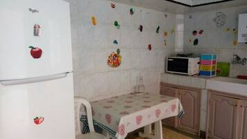Comfort Apartment | Private kitchen | Full-sized fridge, microwave, oven, stovetop