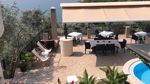 A terrace with outdoor seating, a pool, and a view of the sea. - Monte Perla Residence (Sveti Stefan)