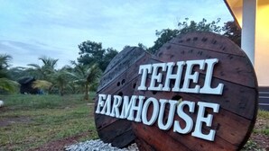 A wooden sign with the text "TEHEL FARMHOUSE" indicating the name of the property. - Tehel Farmhouse (Jasin)