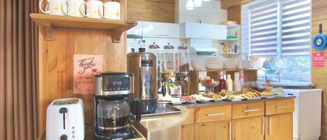 A kitchen with wooden cabinets, a coffee maker, and a toaster.