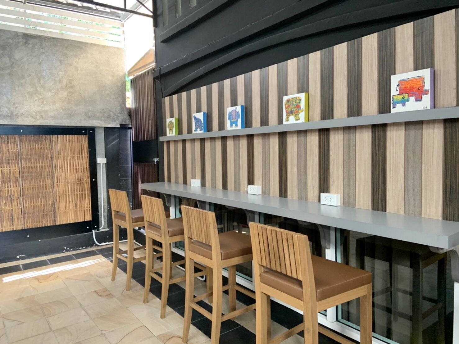 A bar area with wooden chairs and a long counter.