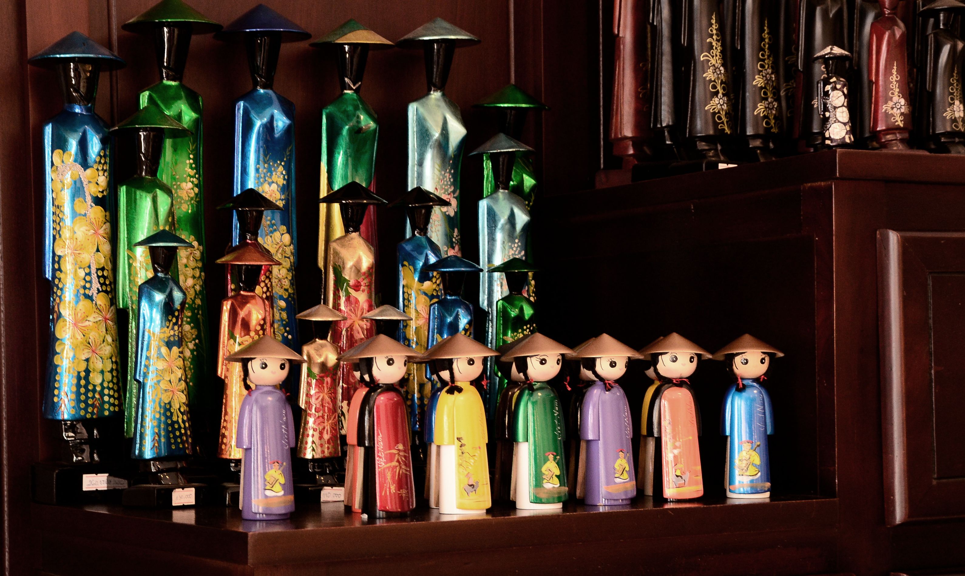 A collection of decorative bottles and figurines on a shelf.