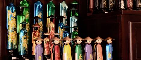 A collection of decorative bottles and figurines on a shelf.